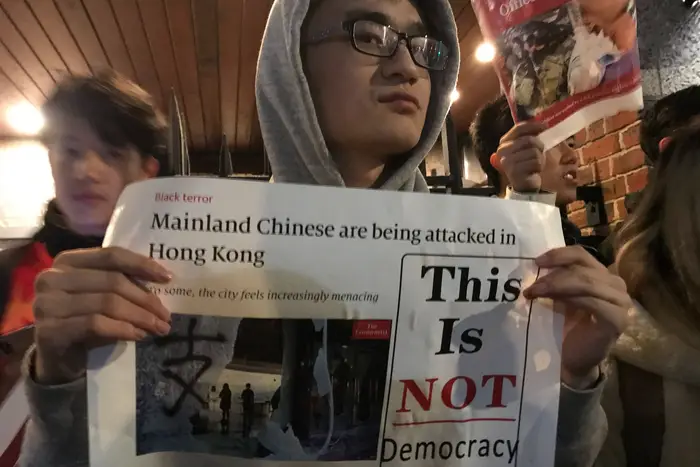 A pro-Beijing protester outside an NYU event on the Hong Kong crisis.